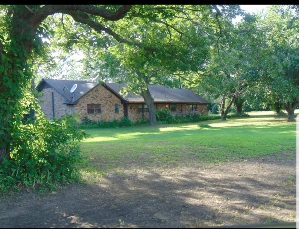 a view of a house with yard and a garden