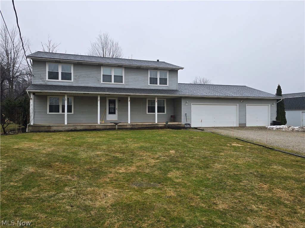 2672 Crackel Road Aurora, OH 44202 - Photo 24 of 38 Traditional-style house featuring covered porch, gravel driveway, a front yard, and an attached garage