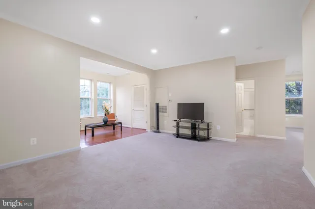 a big room with windows and a dresser