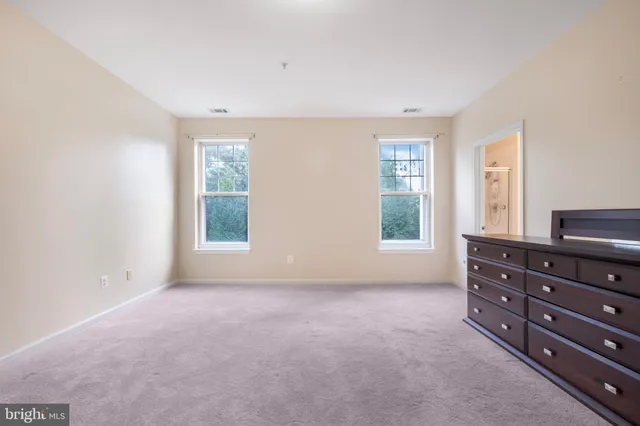 a living room with lots of furniture and a painting on the wall