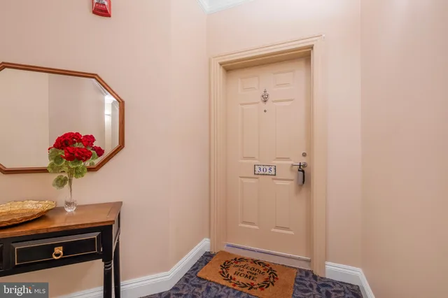 a bath room with a table and a potted plant