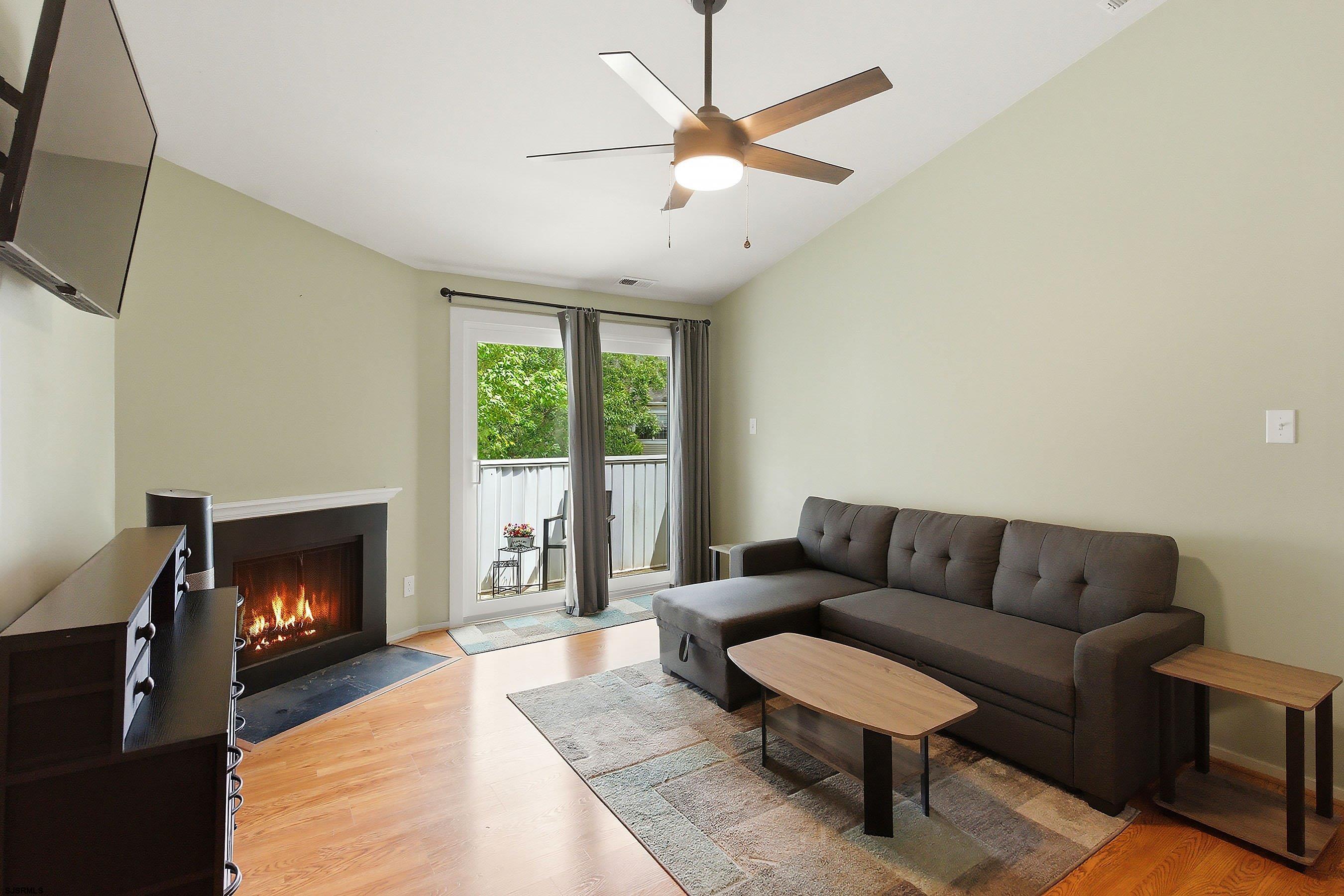 224 Meadow Ridge Road, Unit 224 Smithville, NJ 08205 - Photo 4 of 22 a living room with furniture and a fireplace
