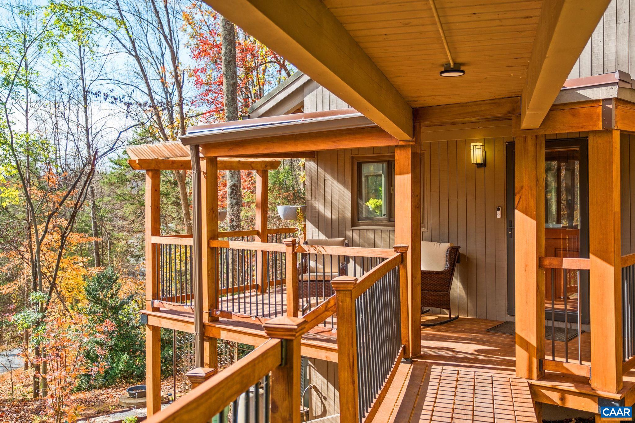 247 Blue Rock Ridge Charlottesville, VA 22903 - Photo 12 of 64 a view of a balcony with wooden floor and iron fence