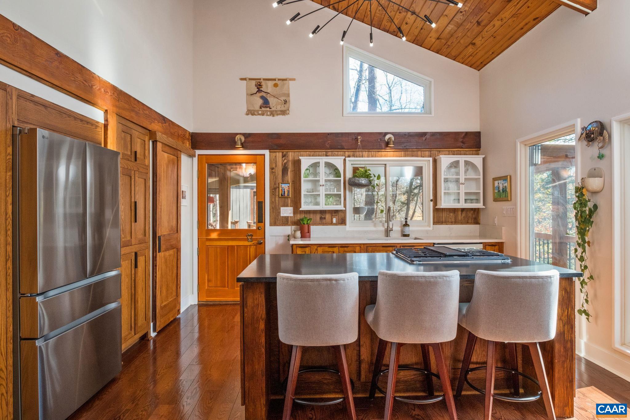 247 Blue Rock Ridge Charlottesville, VA 22903 - Photo 14 of 64 a dining area with stainless steel appliances granite countertop a dining table chairs and a large window