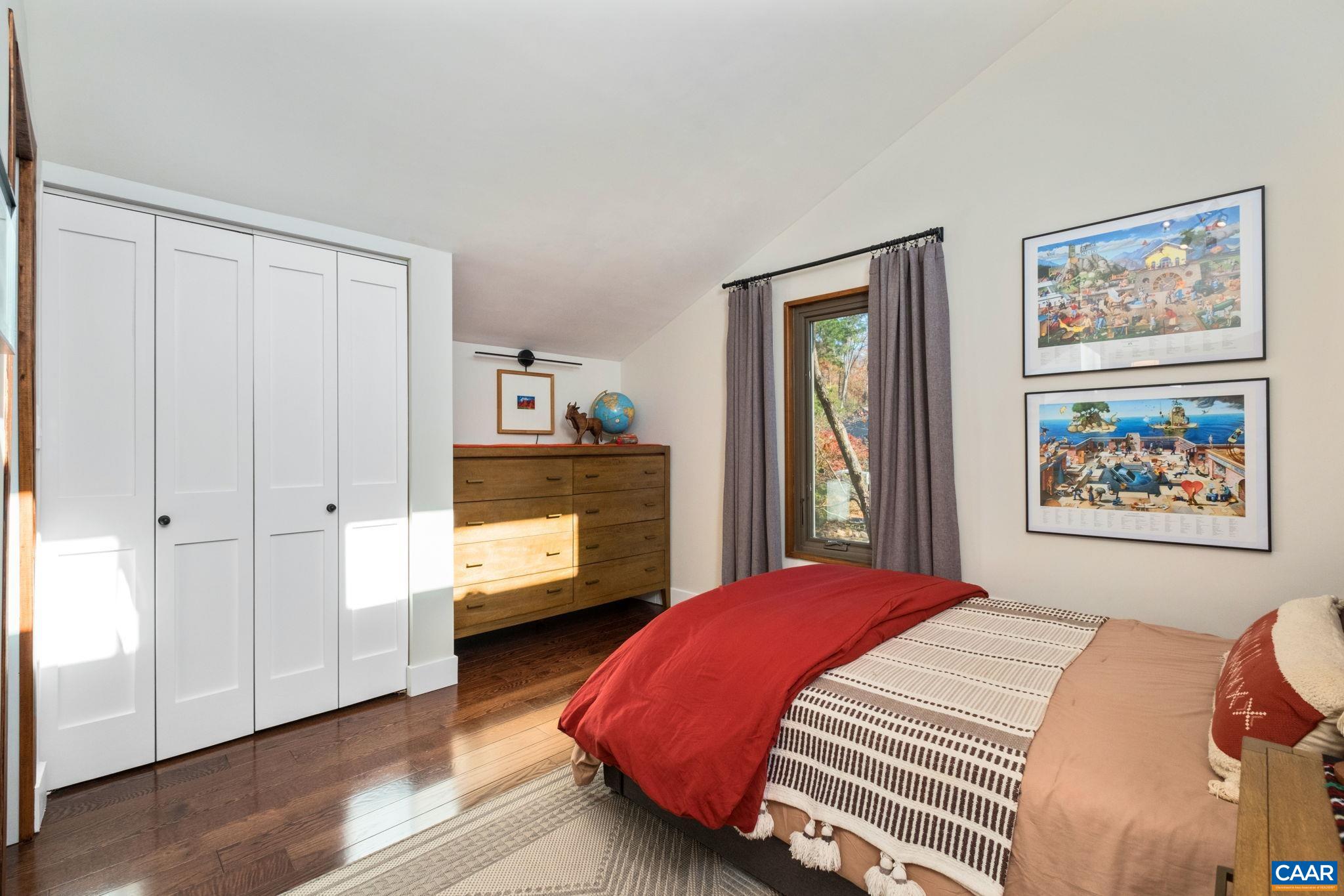 247 Blue Rock Ridge Charlottesville, VA 22903 - Photo 38 of 64 a bedroom with a bed and a painting on the wall