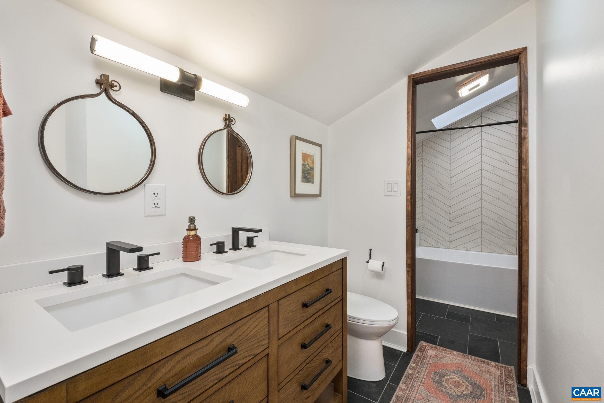 247 Blue Rock Ridge Charlottesville, VA 22903 - Photo 45 of 64 a bathroom with a granite countertop sink toilet and a mirror