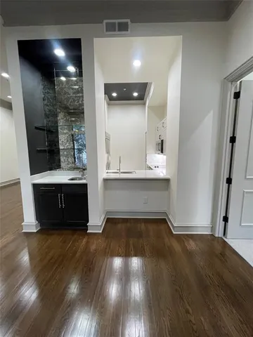 a view of kitchen with cabinets and wooden floor