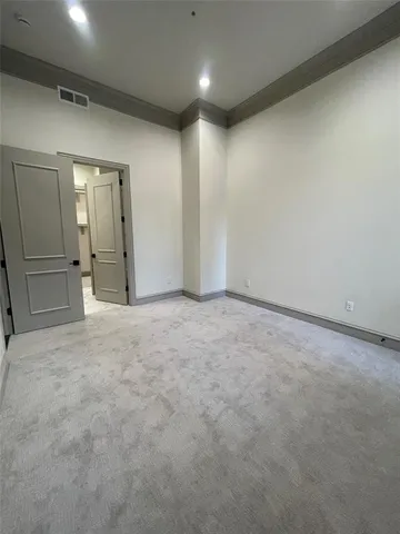 an empty room with a cabinet and mirrors