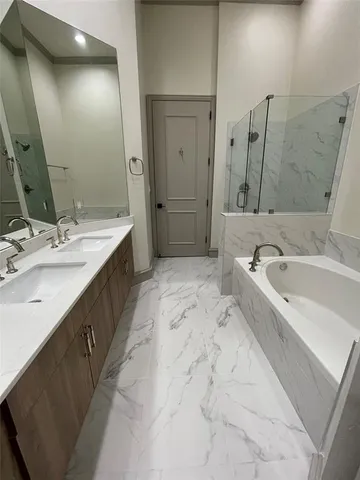 a spacious bathroom with a bathtub sink and mirror