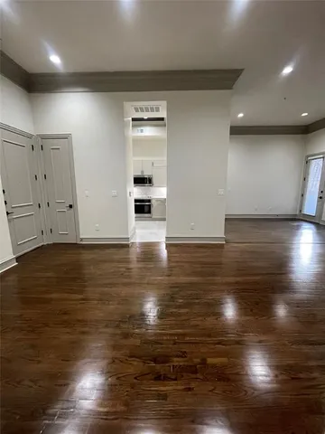 an empty room with wooden floor