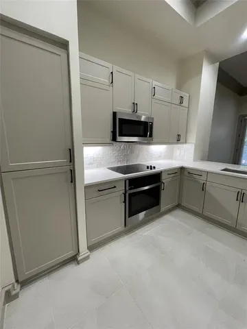 a kitchen with stainless steel appliances a stove and a refrigerator