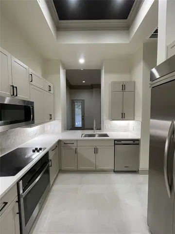 a large white kitchen with a stove and a sink
