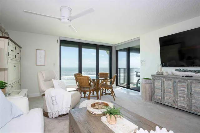 a dining room with furniture and garden view