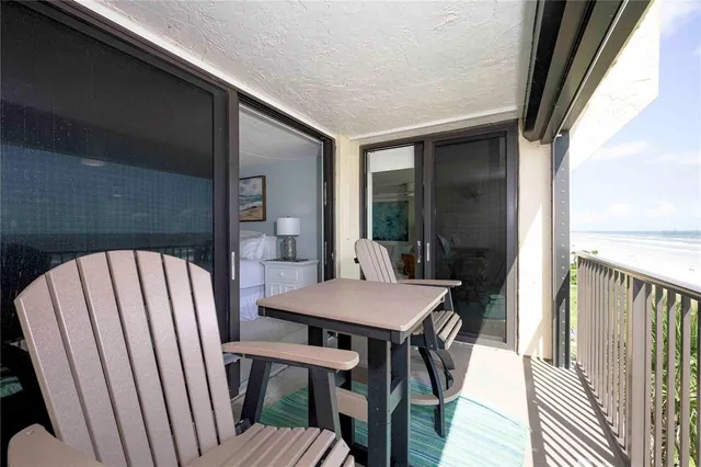 a view of a chairs and table in back of the house