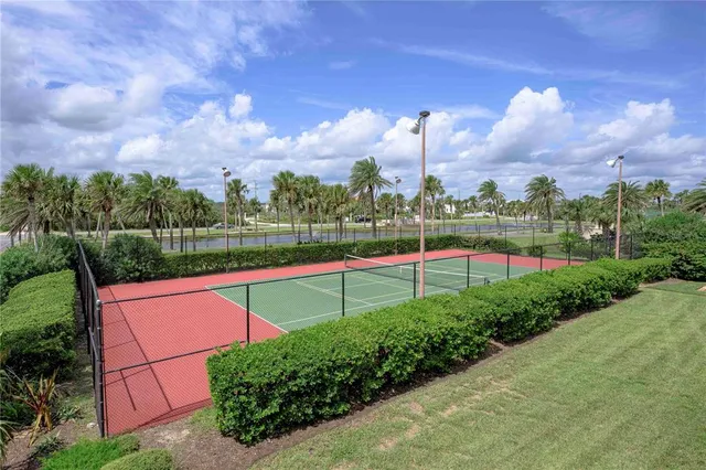 a view of a tennis ground with a small yard