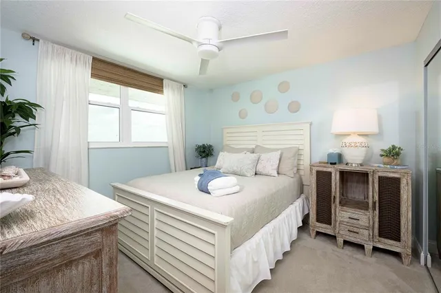 a kitchen with stainless steel appliances granite countertop a sink a stove a refrigerator cabinets and chairs