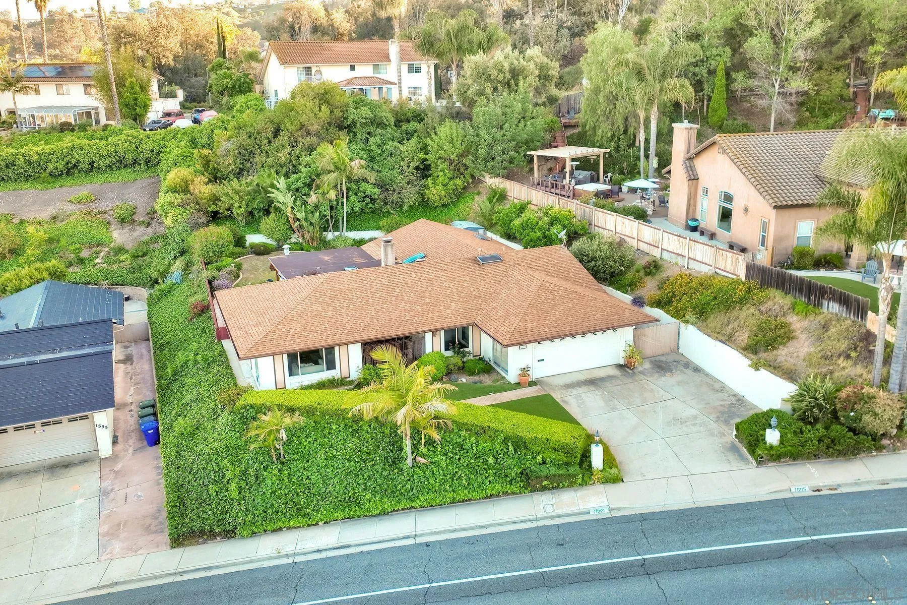 an aerial view of a house with a garden and trees