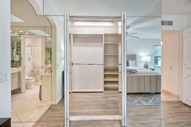 a bathroom with a double vanity sink toilet and shower