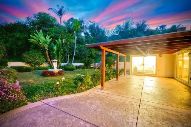 a front view of a house with swing and slide