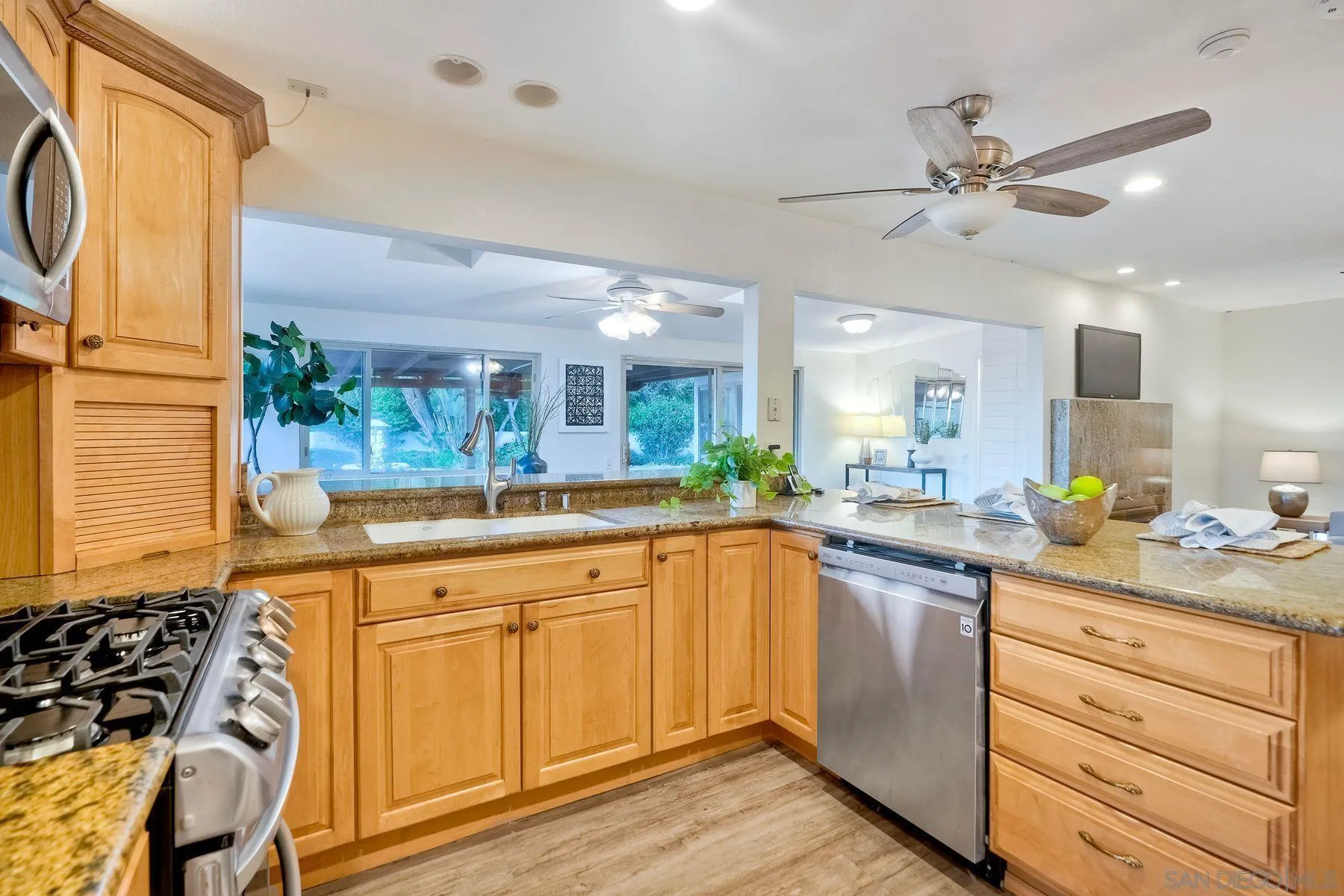 1605 Swallow Drive El Cajon, CA 92020 - Photo 7 of 39 a kitchen with a sink cabinets and wooden floor
