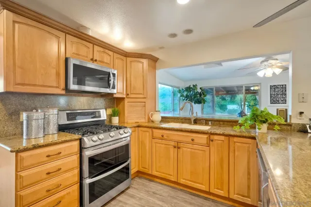 a kitchen with a sink stove and microwave