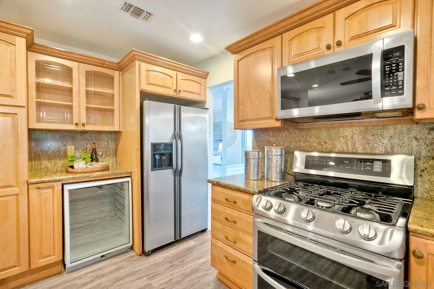 1605 Swallow Drive El Cajon, CA 92020 - Photo 10 of 39 a kitchen with stainless steel appliances granite countertop a stove microwave and refrigerator