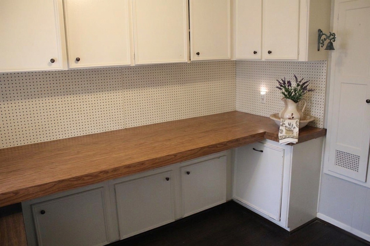 206 Riverside Street Highlands, TX 77562 - Photo 6 of 12 Rare bonus space perfect for crafts, hobbies, or a home office featuring an extra long butcher block countertop, abundant upper and lower cabinetry, and pegboard backsplash for total organization.