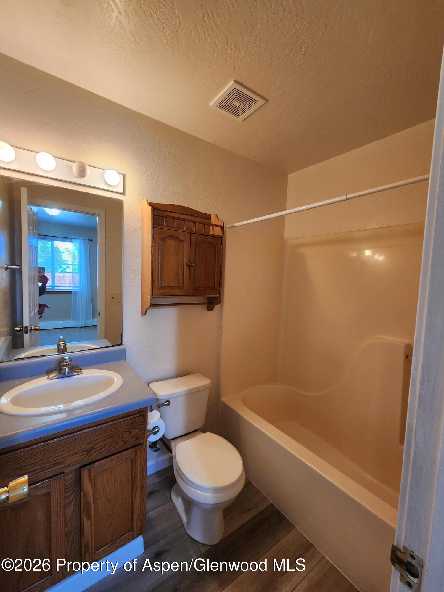 883 Taugenbaugh Boulevard Rifle, CO 81650 - Photo 15 of 18 a bathroom with a sink a toilet and shower