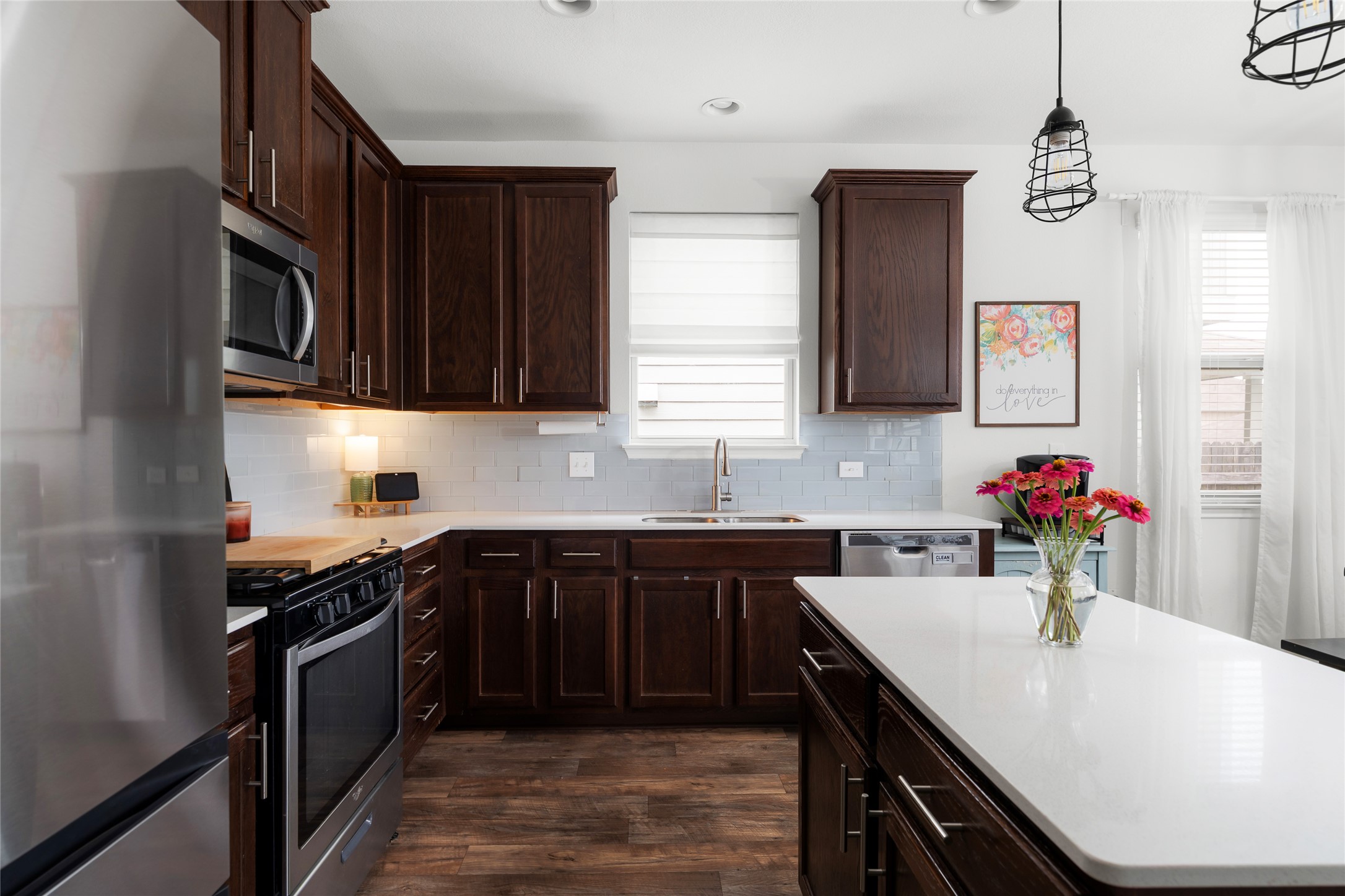 249 Wapiti Road Buda, TX 78610 - Photo 11 of 21 A well-appointed kitchen features rich cabinetry, lustrous countertops, and a full suite of stainless steel appliances.