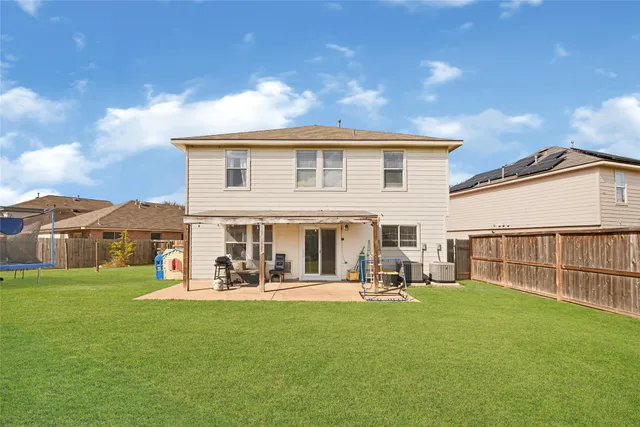 a view of a house with a big yard and large trees