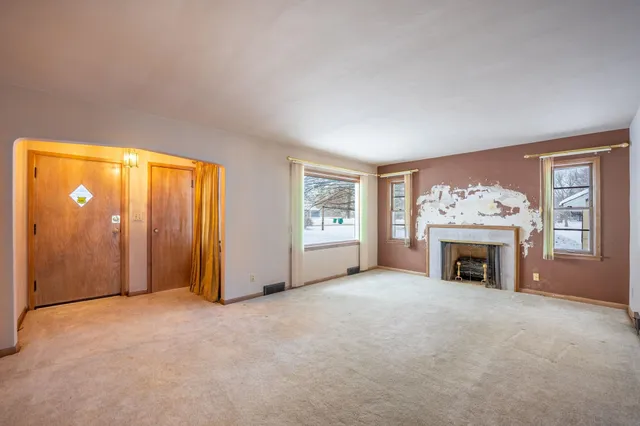 an empty room with furniture and a fireplace