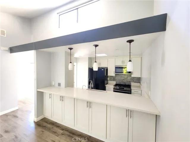 a kitchen with stainless steel appliances a refrigerator and cabinets