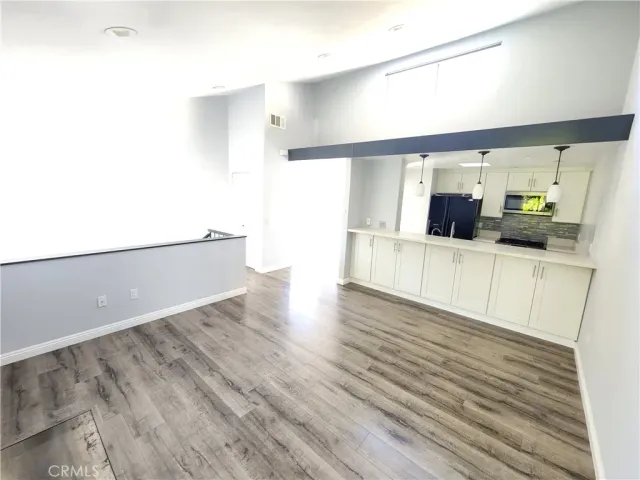a view of a kitchen with a sink and a refrigerator