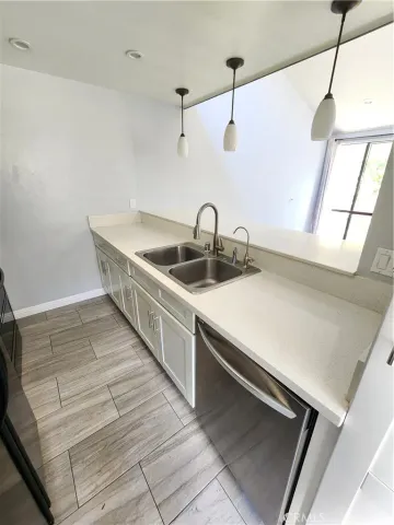 a kitchen with kitchen island a sink and wooden floor