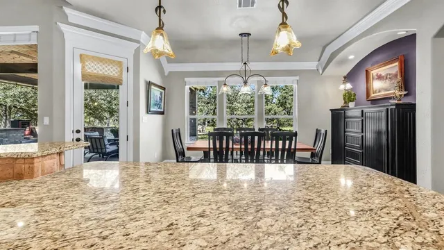 a kitchen with a table and chairs
