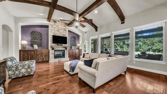 a living room with furniture fireplace and flat screen tv