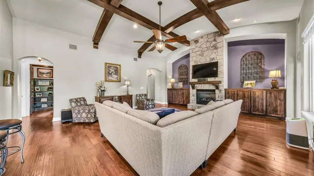 a living room with fireplace furniture and a flat screen tv