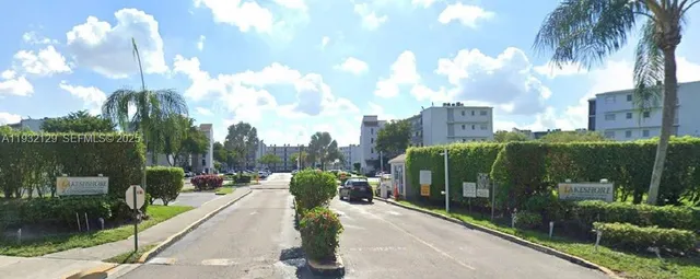 a view of a garden with a building in the background