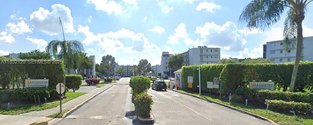 a view of a garden with a building in the background