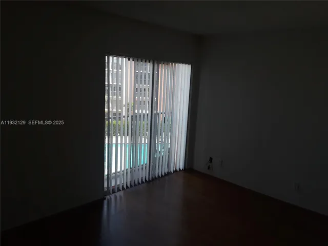 a view of wooden floor and windows
