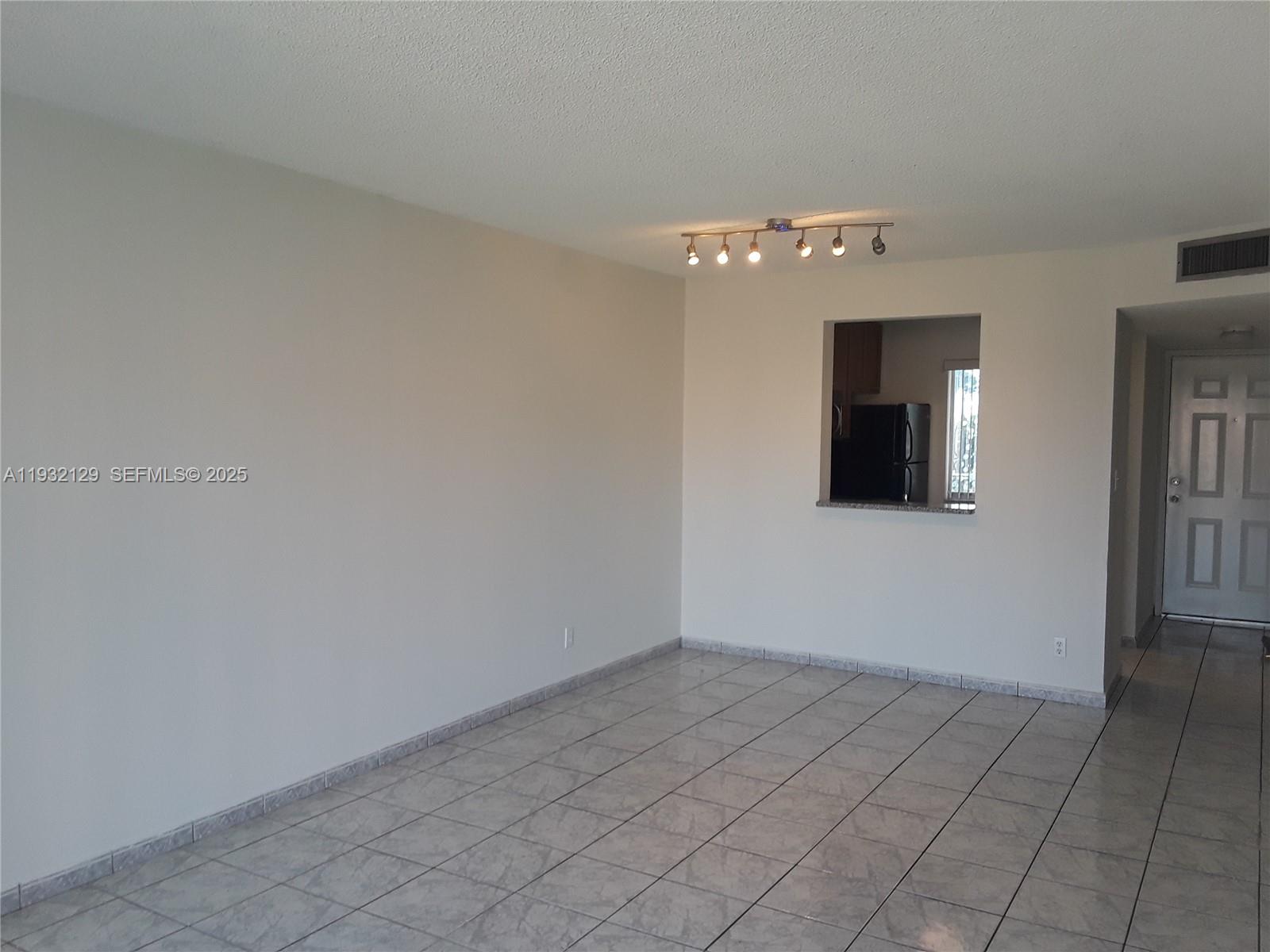 8700 Sherman Circle North, Unit 407 Miramar, FL 33025 - Photo 4 of 12 wooden floor in an empty room with a window