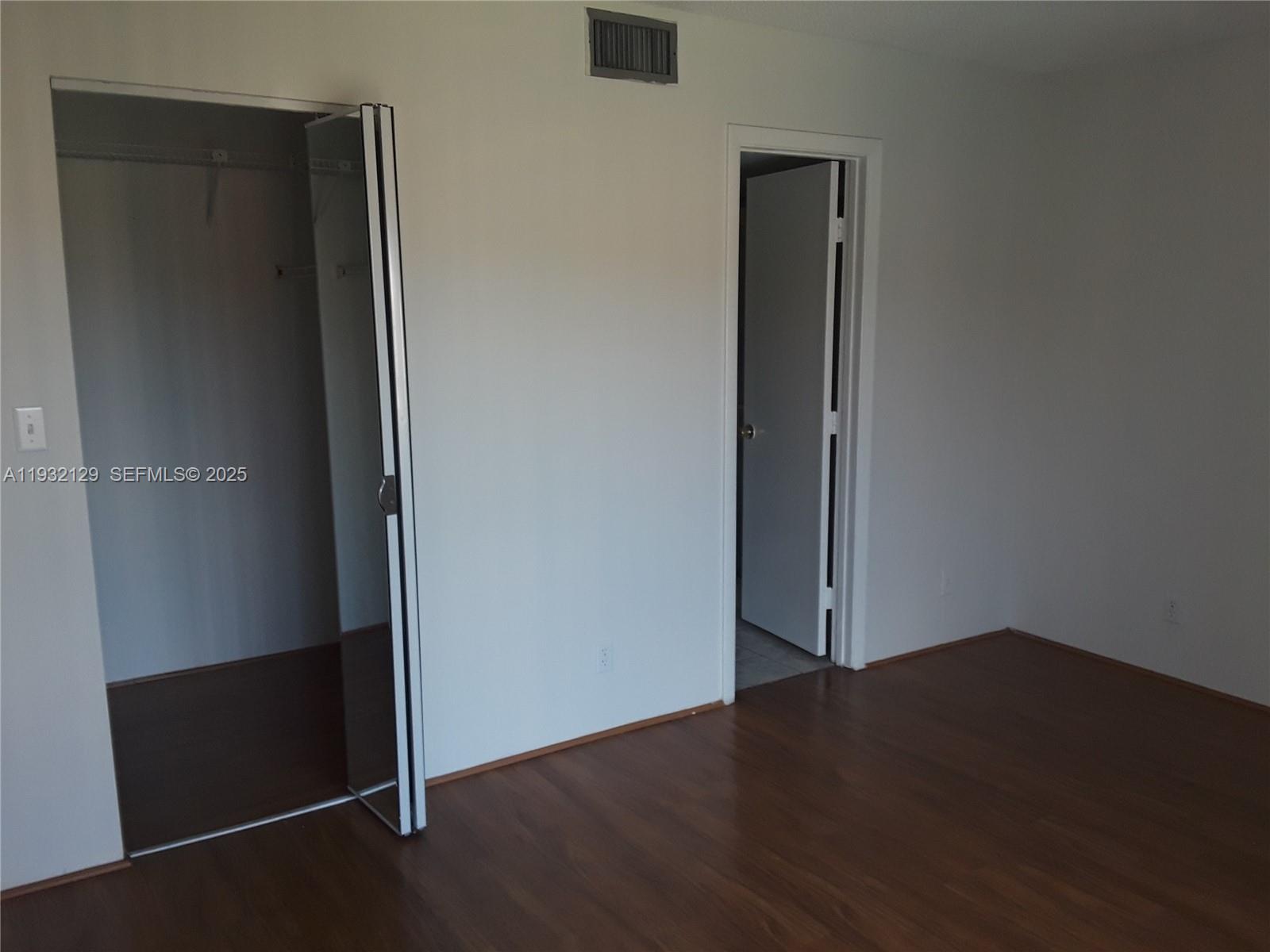 8700 Sherman Circle North, Unit 407 Miramar, FL 33025 - Photo 10 of 12 an empty room with wooden floor