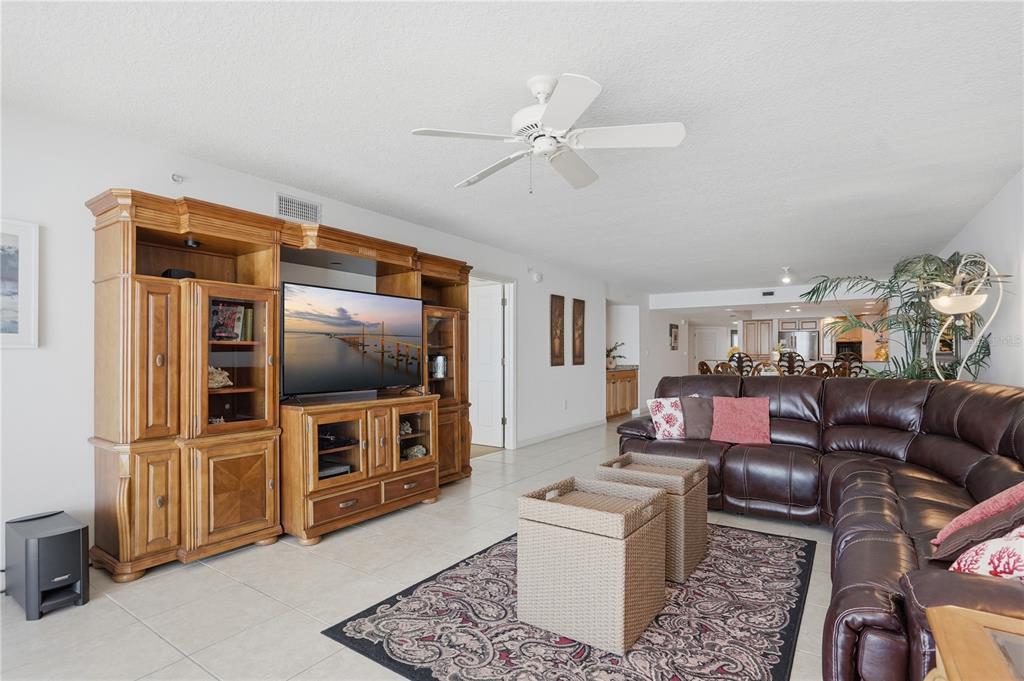 16326 Gulf Boulevard, Unit 307 Redington Beach, FL 33708 - Photo 12 of 43 a living room with furniture and a flat screen tv