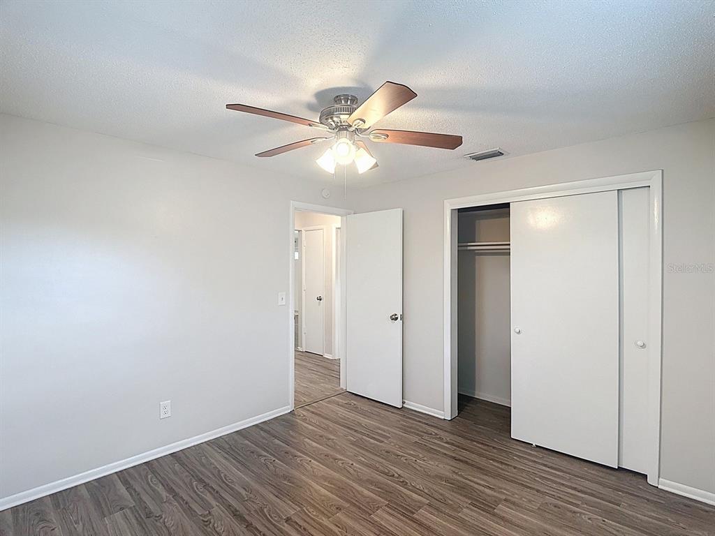 11320 Currie Lane Largo, FL 33774 - Photo 11 of 40 a view of an empty room with window and wooden floor