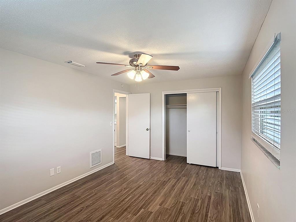 11320 Currie Lane Largo, FL 33774 - Photo 15 of 40 wooden floor in an empty room with a window