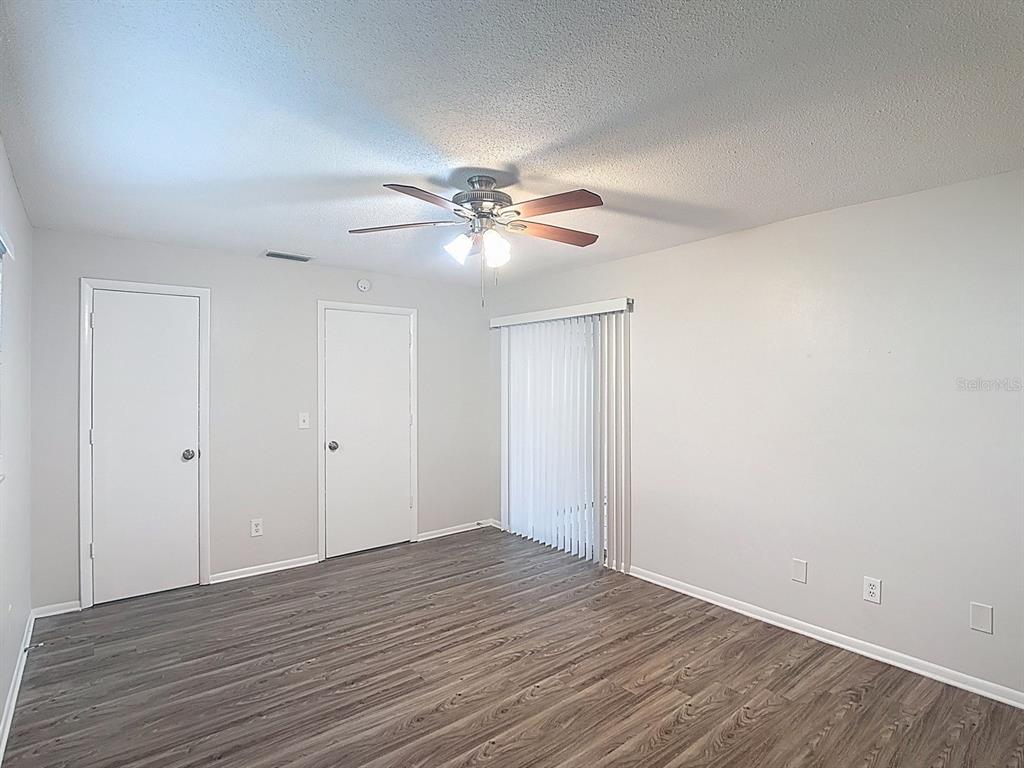 11320 Currie Lane Largo, FL 33774 - Photo 16 of 40 a view of an empty room with a chandelier fan