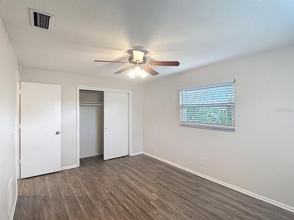 11320 Currie Lane Largo, FL 33774 - Photo 17 of 40 a view of an empty room with wooden floor