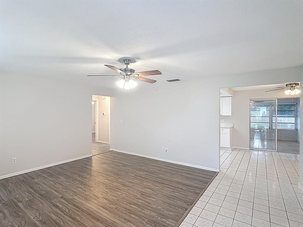 11320 Currie Lane Largo, FL 33774 - Photo 20 of 40 a view of an empty room with window and wooden floor
