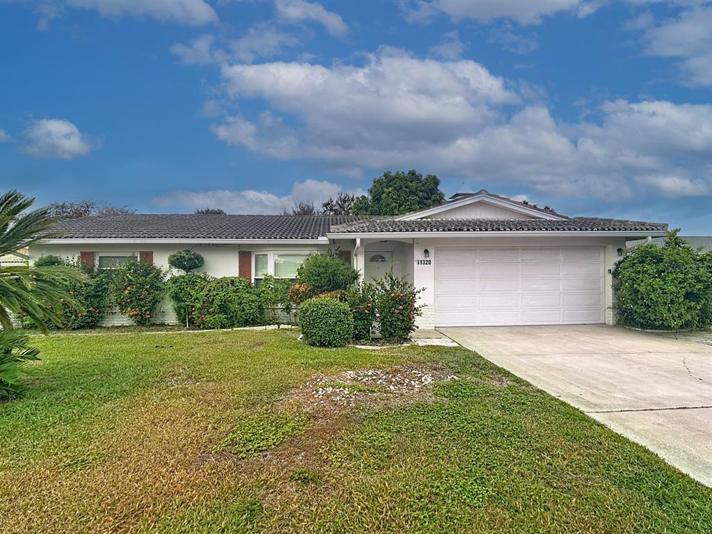 11320 Currie Lane Largo, FL 33774 - Photo 2 of 40 front view of a house with a yard
