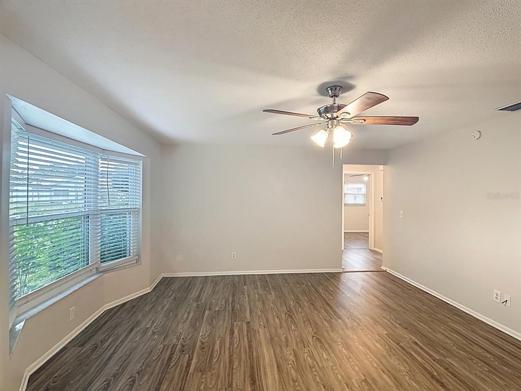11320 Currie Lane Largo, FL 33774 - Photo 23 of 40 wooden floor in an empty room with a window
